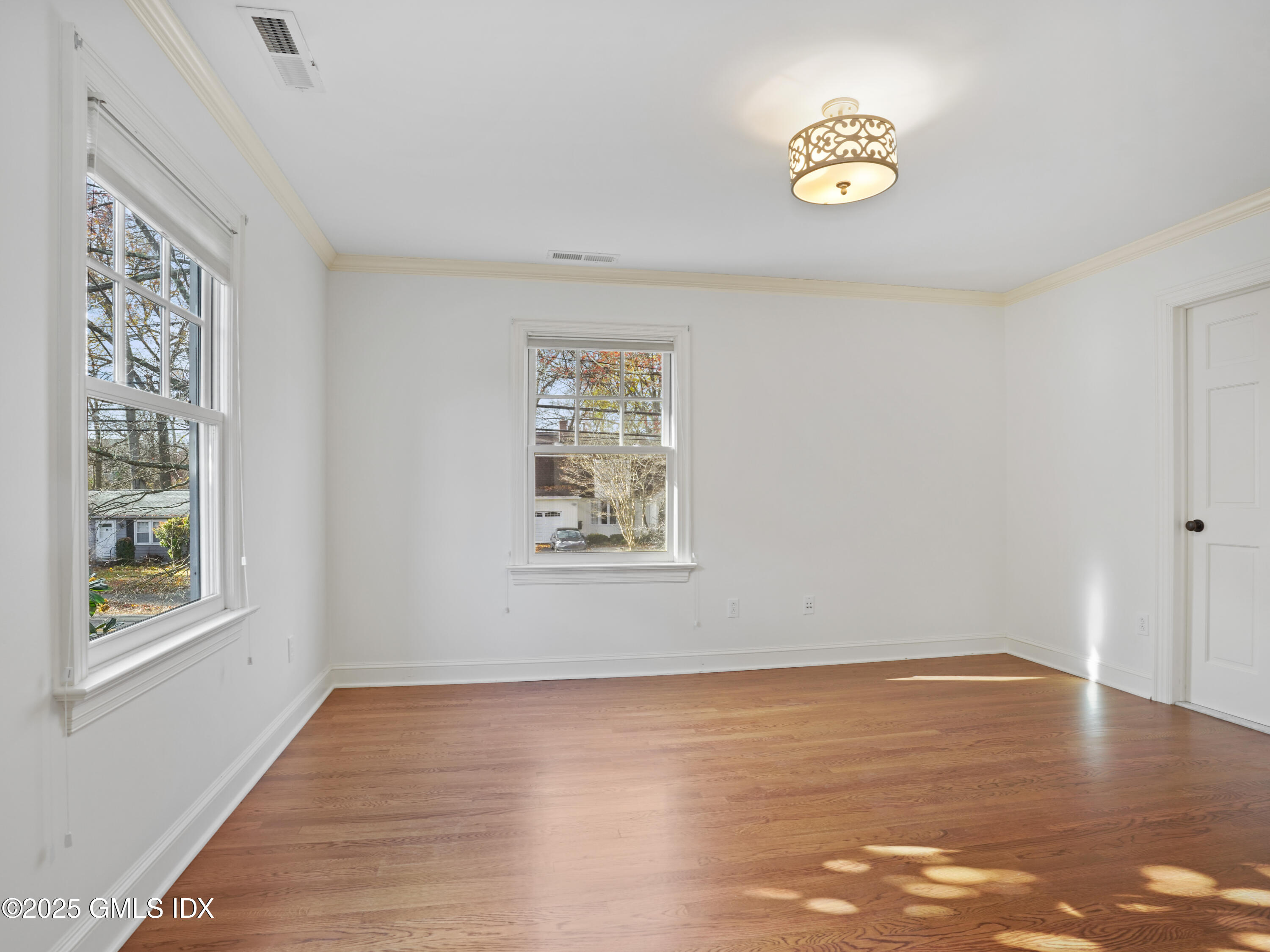77 Sheep Hill Road Riverside, CT 06878 - Photo 19 of 34 a view of an empty room with window and wooden floor