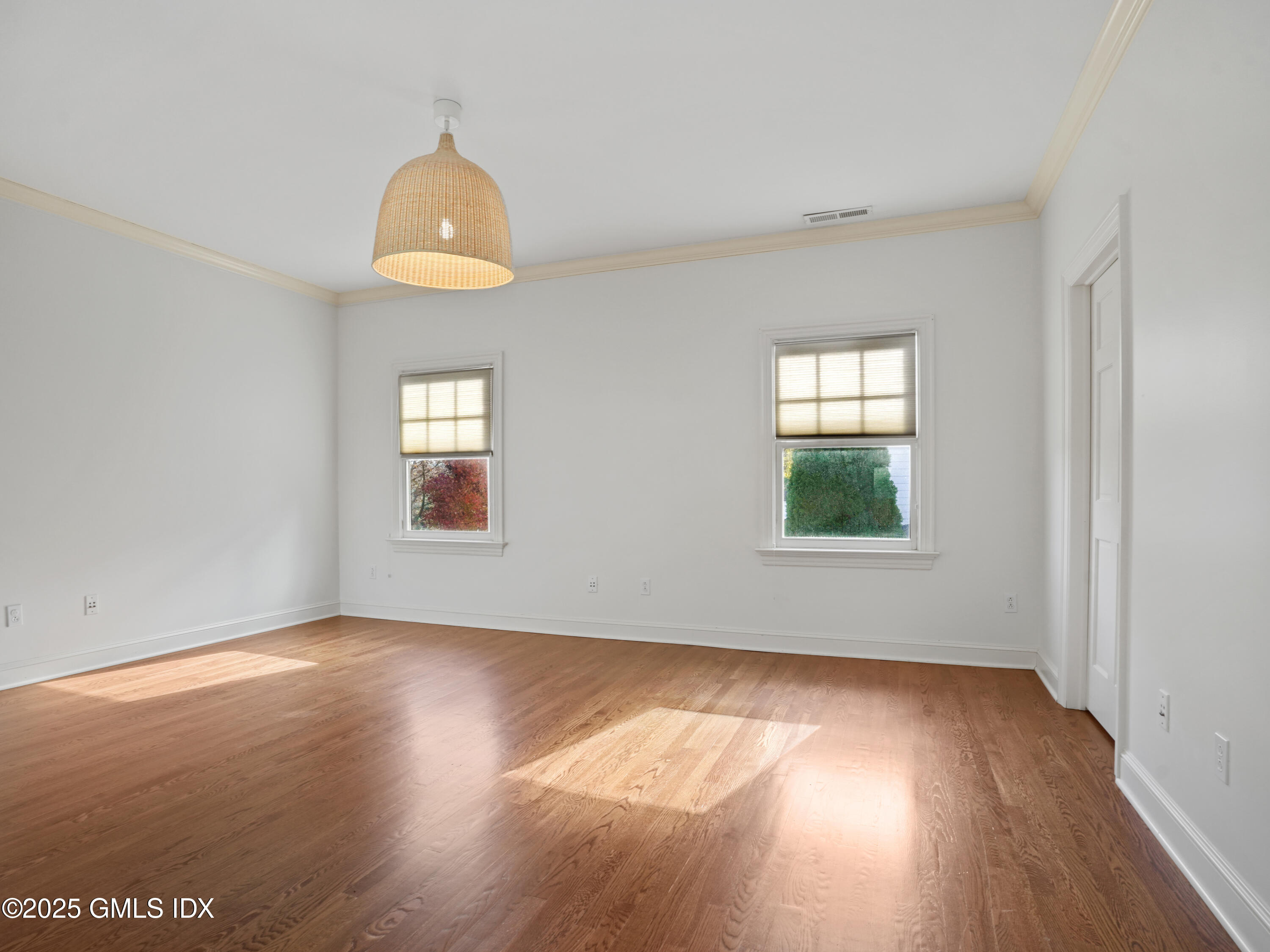 77 Sheep Hill Road Riverside, CT 06878 - Photo 26 of 34 an empty room with wooden floor and windows
