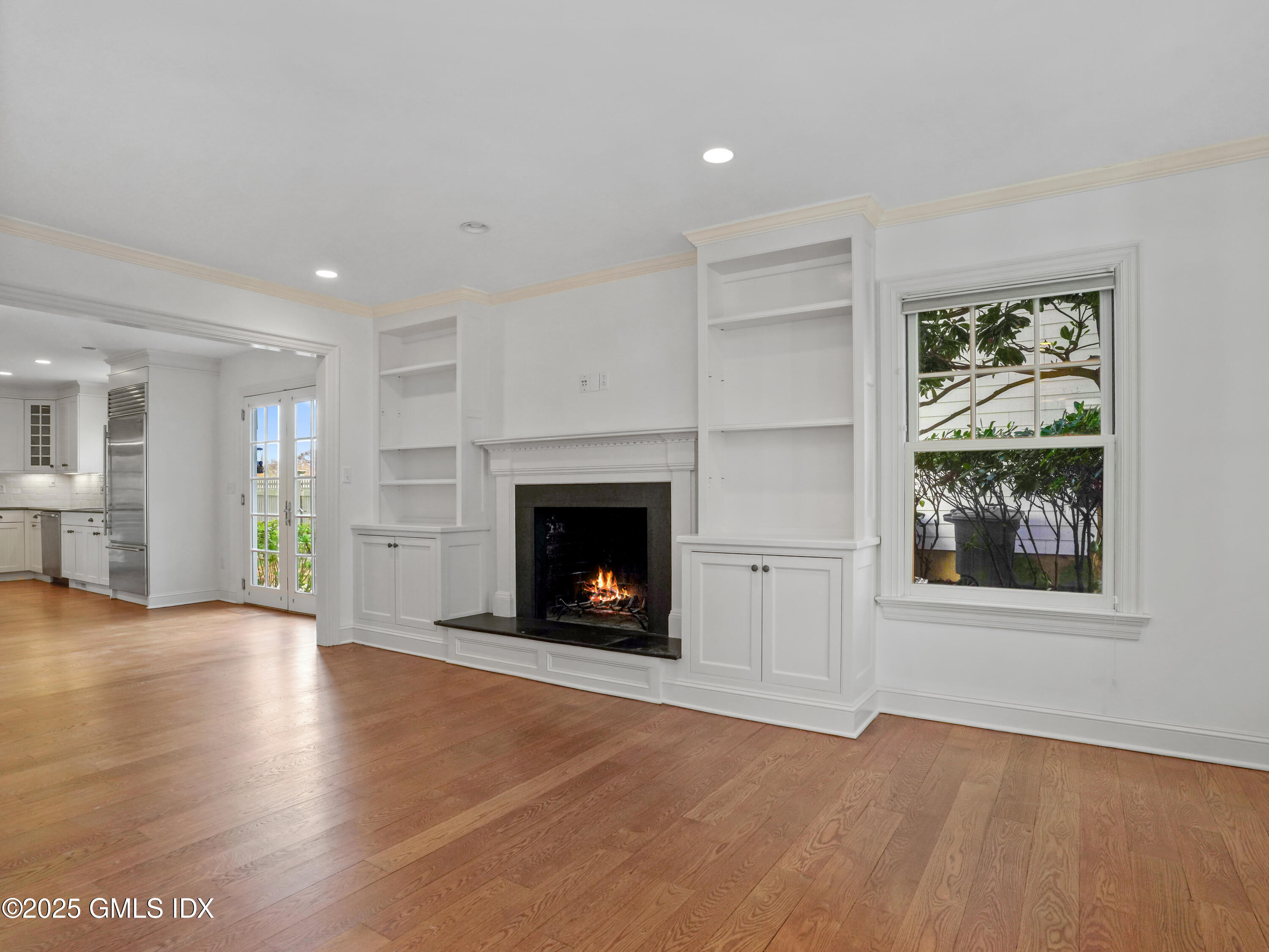 77 Sheep Hill Road Riverside, CT 06878 - Photo 5 of 34 an empty room with windows and a fireplace