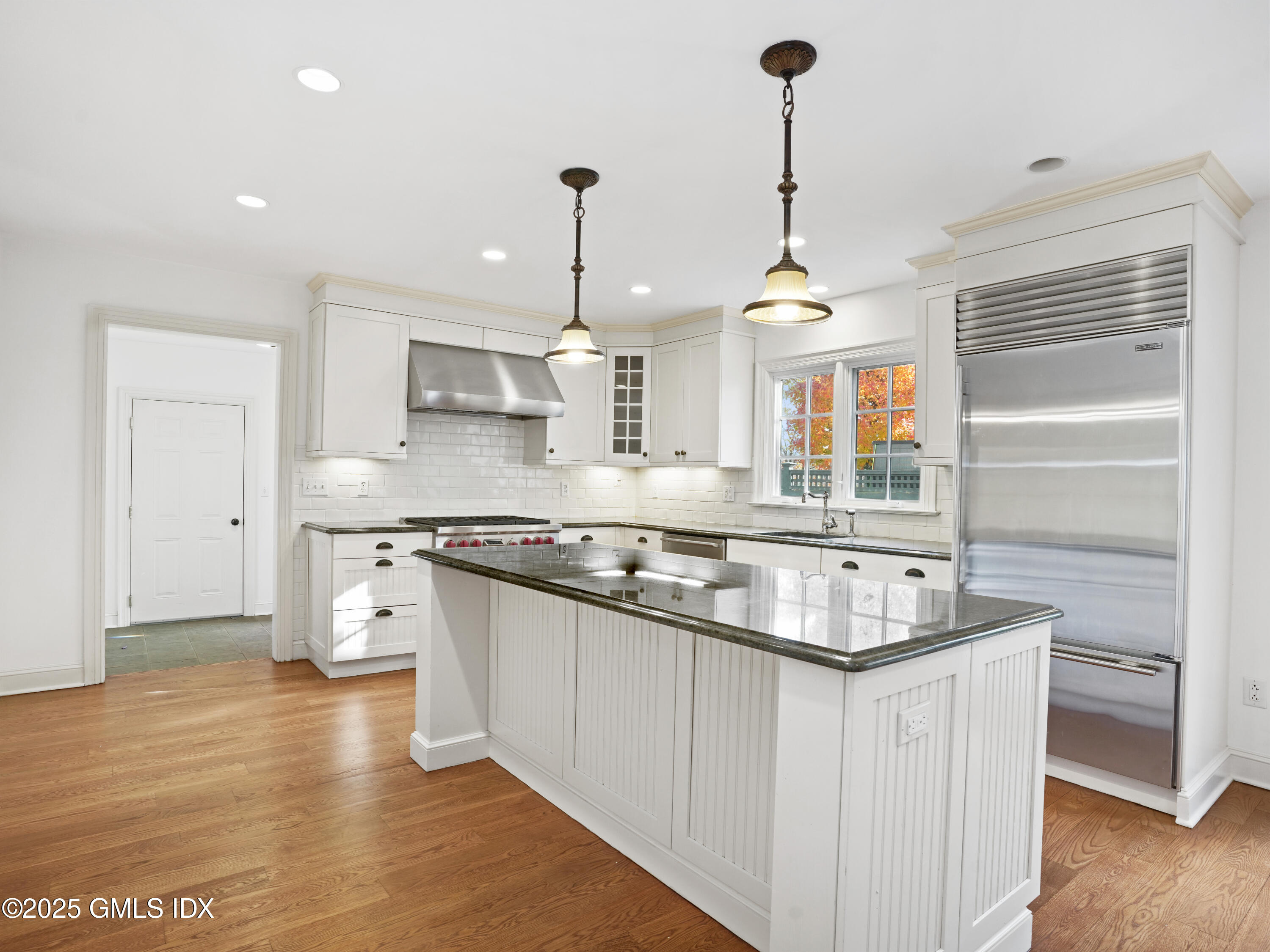 77 Sheep Hill Road Riverside, CT 06878 - Photo 7 of 34 a kitchen with stainless steel appliances granite countertop a sink a stove a refrigerator and island