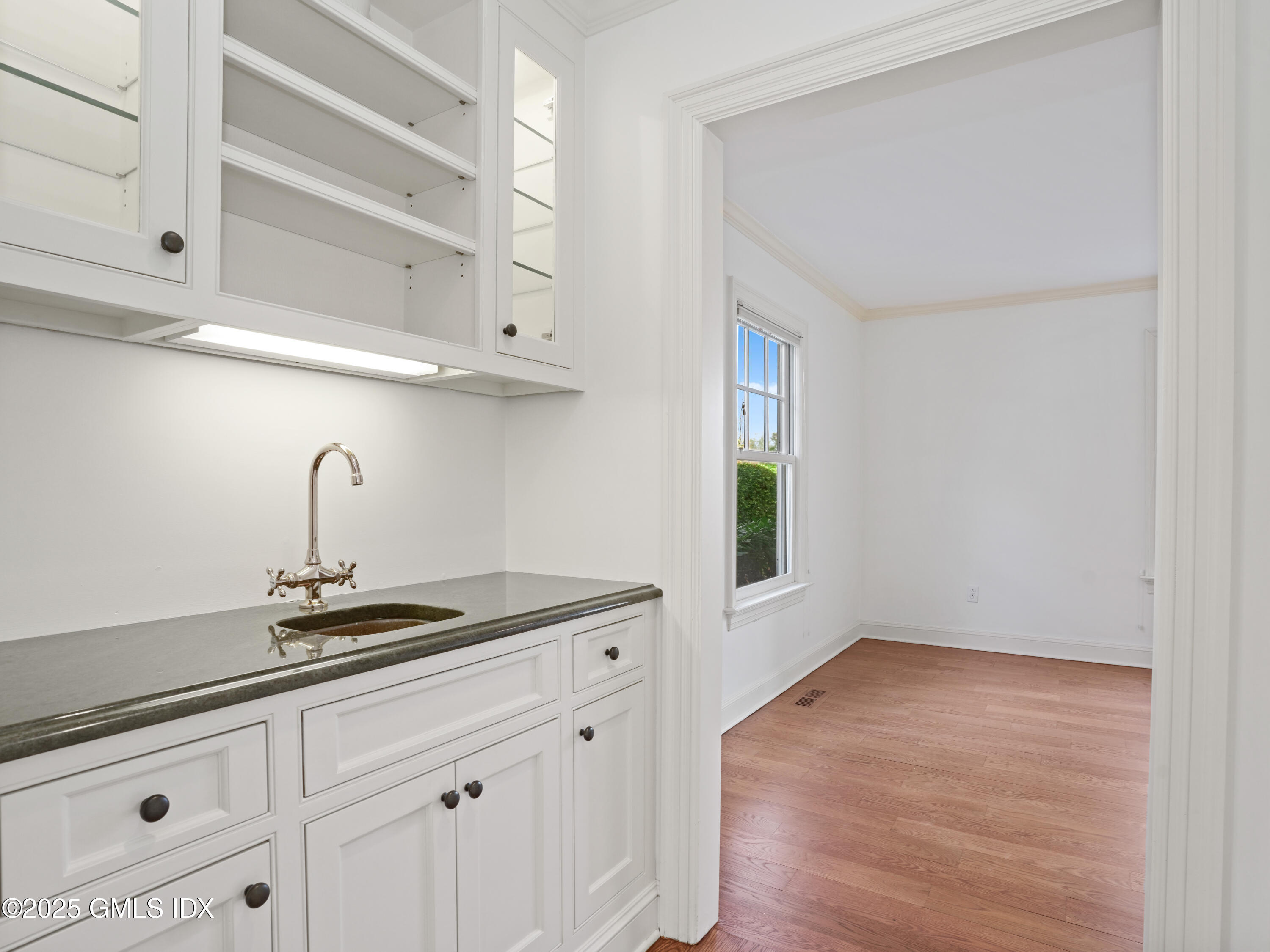 77 Sheep Hill Road Riverside, CT 06878 - Photo 10 of 34 a kitchen with white cabinets and a sink