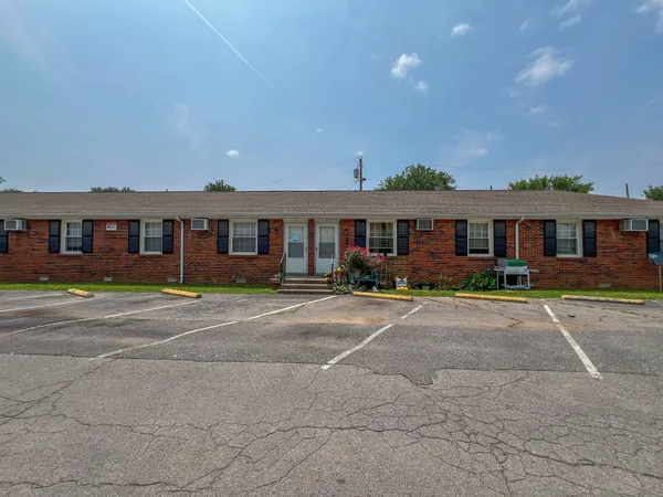 a front view of a residential apartment building with a yard