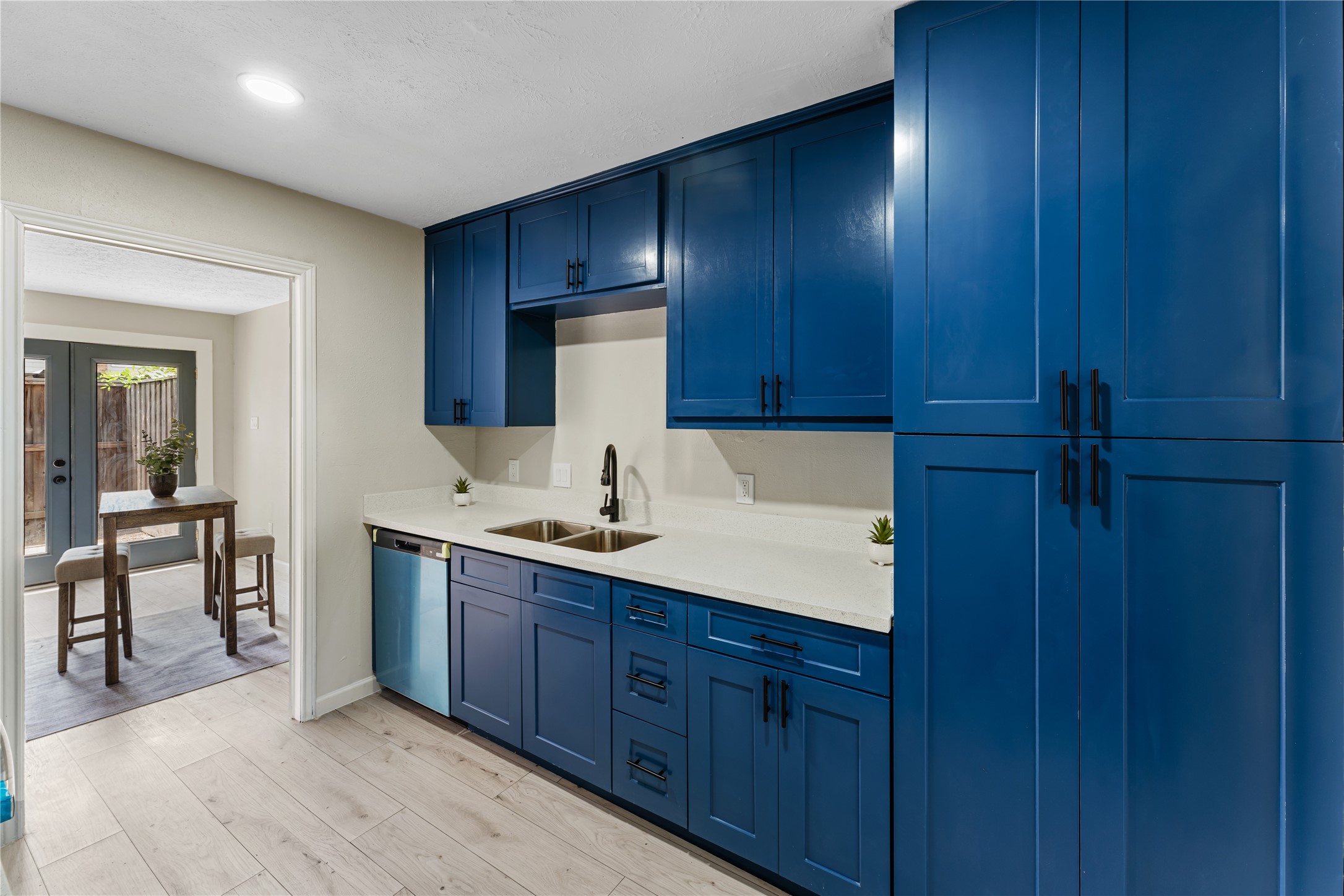 9425 Fondren Road Houston, TX 77074 - Photo 9 of 29 Another view of the kitchen, showing lots of storage space and a well sized pantry on the left side.