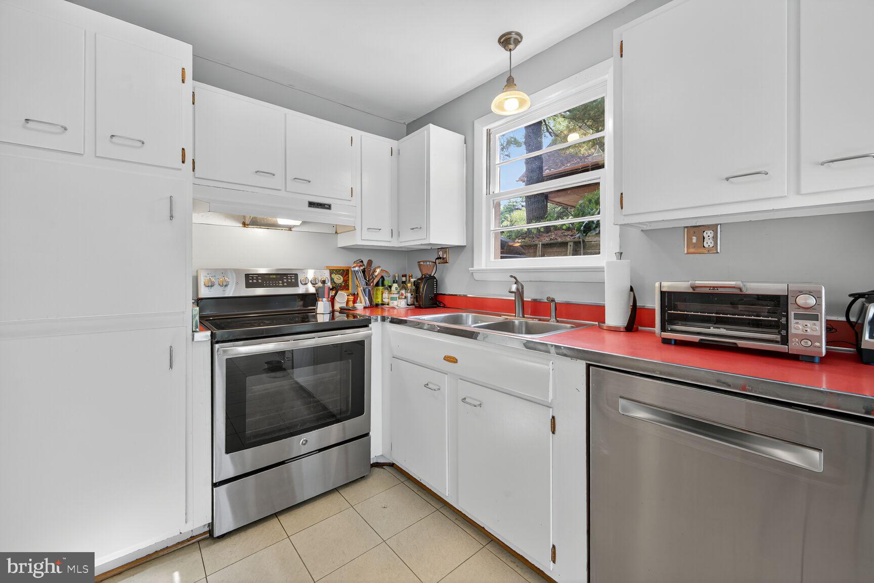 6506 Ridge Drive Bethesda, MD 20816 - Photo 12 of 29 a kitchen with stainless steel appliances granite countertop a sink dishwasher a refrigerator and cabinets with wooden floor