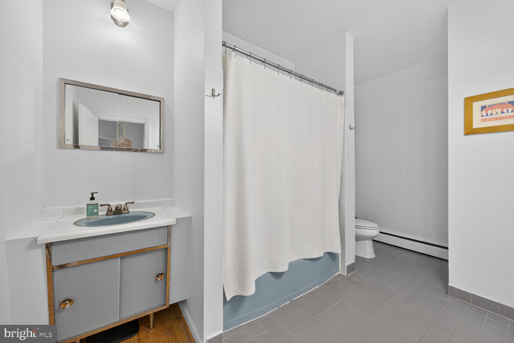 6506 Ridge Drive Bethesda, MD 20816 - Photo 17 of 29 a bathroom with a sink and a mirror