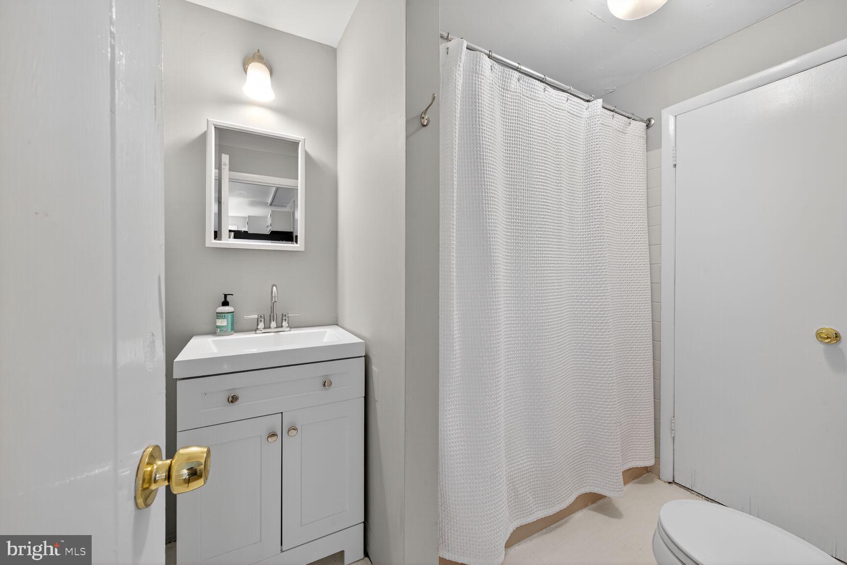 6506 Ridge Drive Bethesda, MD 20816 - Photo 20 of 29 a bathroom with a sink a toilet and shower
