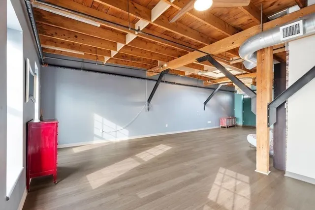 a view of a room with wooden walls and stairs