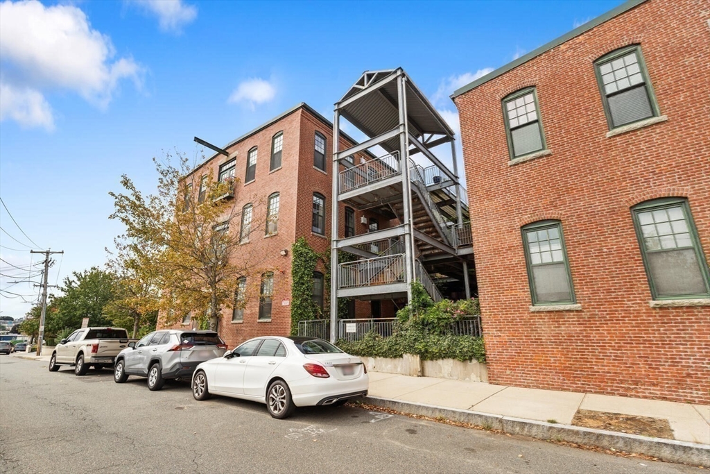 60 Dudley Street, Unit 32 Chelsea, MA 02150 - Photo 24 of 38 a view of a cars park in front of a building