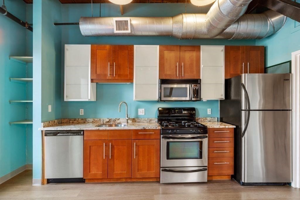60 Dudley Street, Unit 32 Chelsea, MA 02150 - Photo 3 of 38 a kitchen with stainless steel appliances a stove a refrigerator and a sink