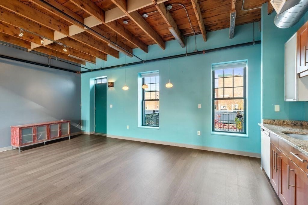 60 Dudley Street, Unit 32 Chelsea, MA 02150 - Photo 4 of 38 a view of an empty room with wooden floor and a window