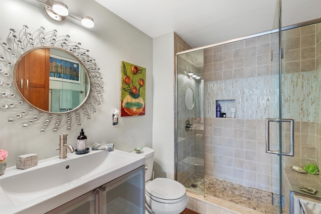 60 Dudley Street, Unit 32 Chelsea, MA 02150 - Photo 7 of 38 a bathroom with a sink mirror toilet and shower