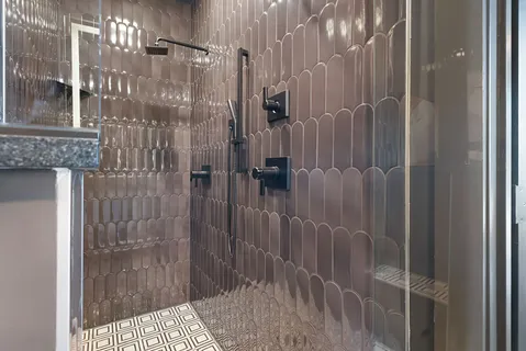 a bathroom with a toilet sink and shower