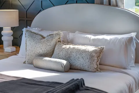 a bedroom with beds and a chandelier