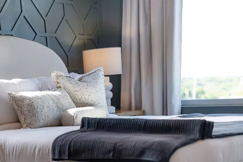 a bedroom with two beds and a flat screen tv