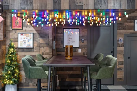 a roof deck with couches and potted plants