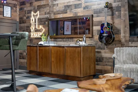 a roof deck with table and chairs with potted plants