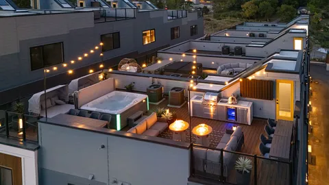 an aerial view of a house with a garden and lake view