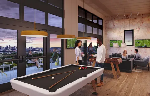 a city view with tall buildings and cars parked on street side