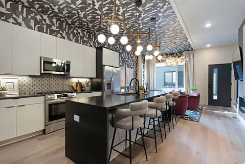 a kitchen with stainless steel appliances a sink stove and cabinets