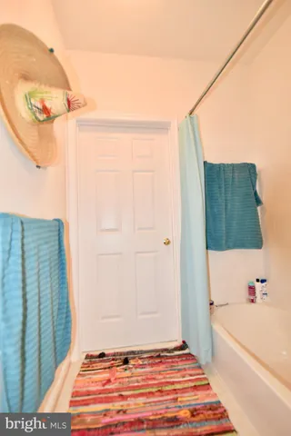 a bathroom with a tub and shower