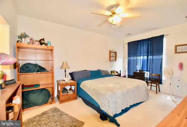 a bedroom with a bed and a fireplace