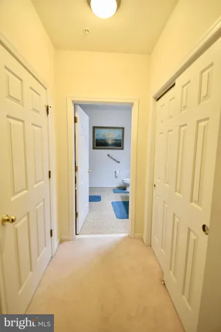 a view of a hallway with wooden shelves