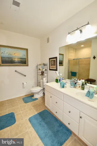 a spacious bathroom with a double vanity sink a mirror and a bathtub