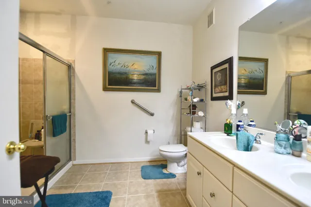 a spacious bathroom with a toilet a sink and mirror