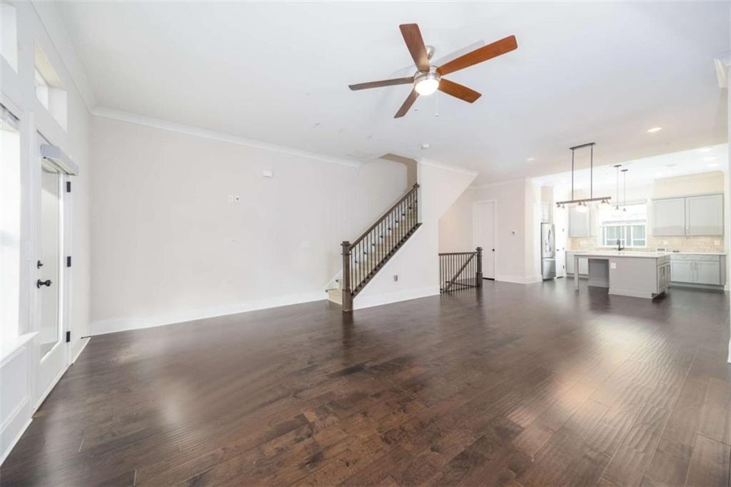 915 Katie Kerr Drive Decatur, GA 30030 - Photo 12 of 30 a view of a livingroom with wooden floor and a ceiling fan