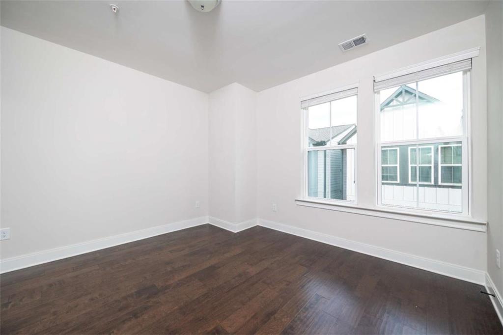 915 Katie Kerr Drive Decatur, GA 30030 - Photo 13 of 30 a view of an empty room with wooden floor and a window