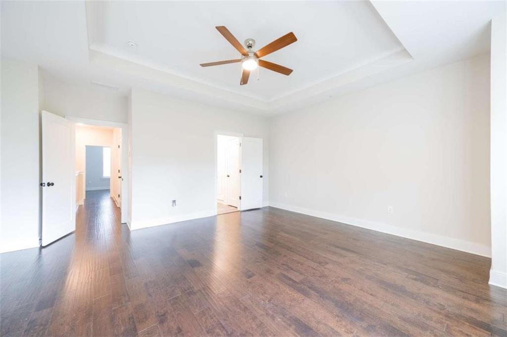 915 Katie Kerr Drive Decatur, GA 30030 - Photo 17 of 30 an empty room with wooden floor and ceiling fan