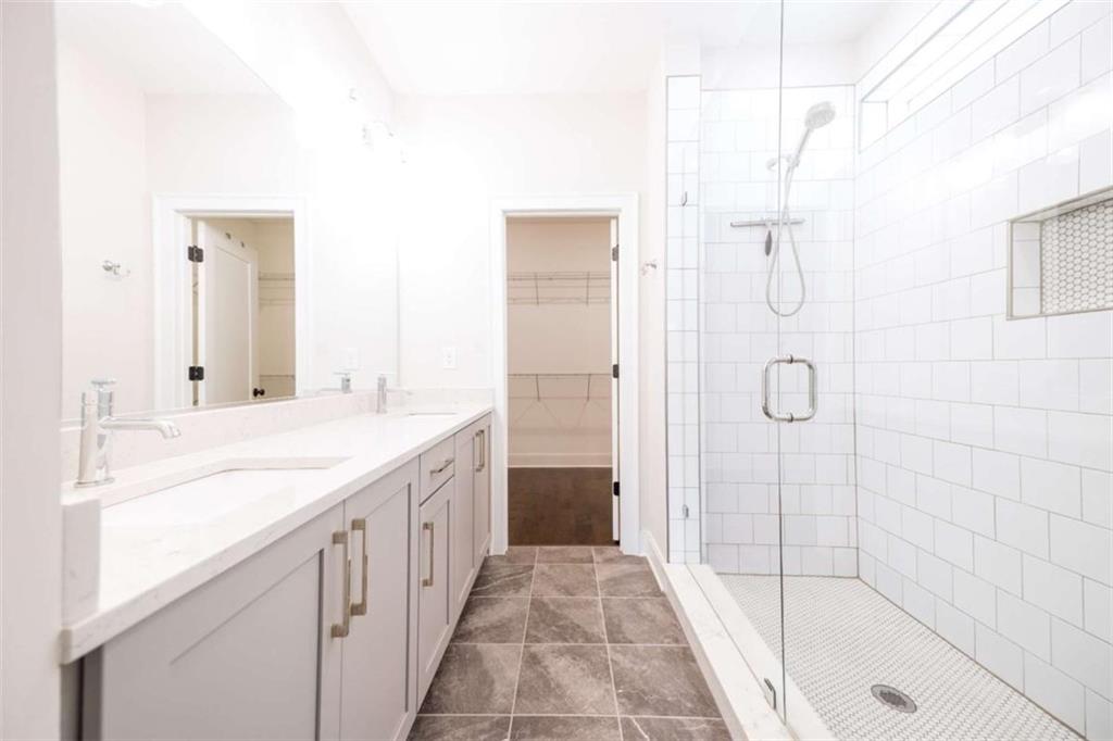 915 Katie Kerr Drive Decatur, GA 30030 - Photo 18 of 30 a bathroom with a granite countertop sink a shower and a mirror