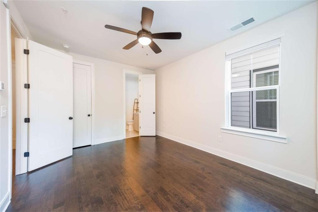 915 Katie Kerr Drive Decatur, GA 30030 - Photo 26 of 30 an empty room with wooden floor fan and windows