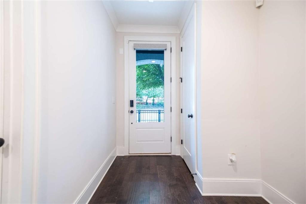 915 Katie Kerr Drive Decatur, GA 30030 - Photo 5 of 30 a view of a hallway with wooden floor and a white door