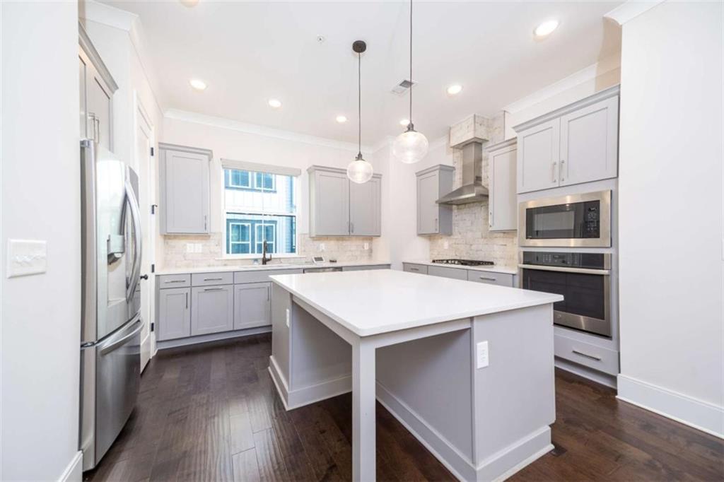 915 Katie Kerr Drive Decatur, GA 30030 - Photo 7 of 30 a kitchen with a refrigerator a sink and a oven