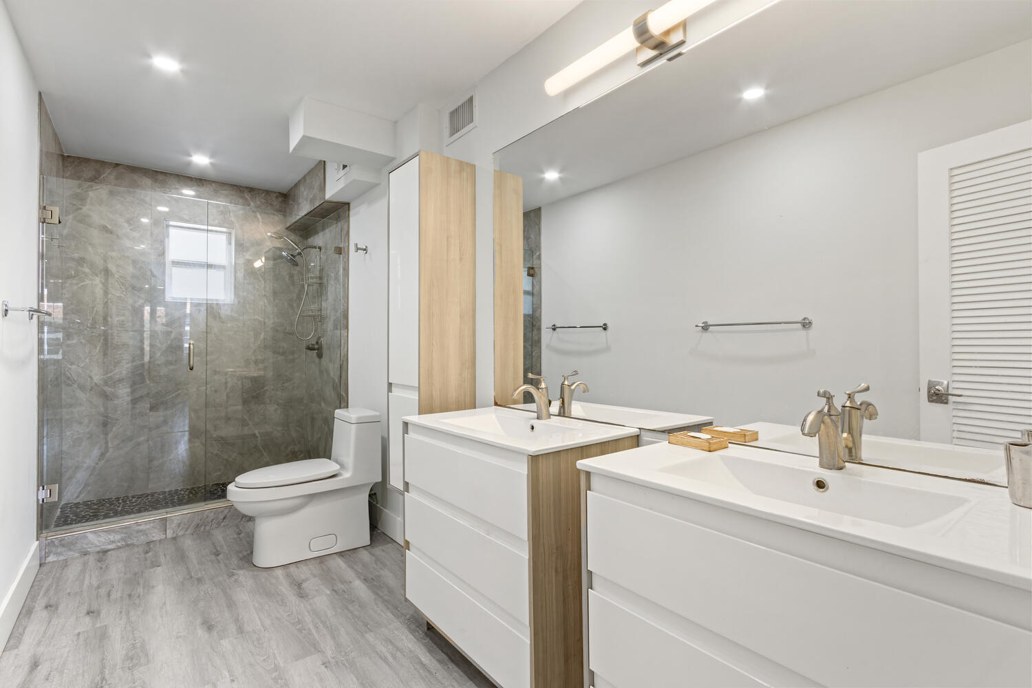 2871 North Ocean Boulevard, Unit V443 Boca Raton, FL 33431 - Photo 21 of 49 a bathroom with a sink a toilet a mirror and shower