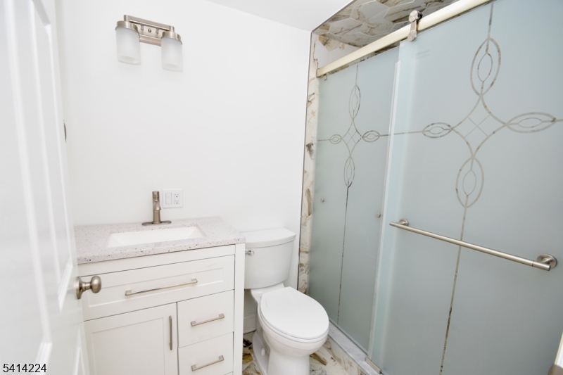 5612 Berkshire Valley Road Oak Ridge, NJ 07438 - Photo 13 of 19 a bathroom with a toilet a sink and a shower