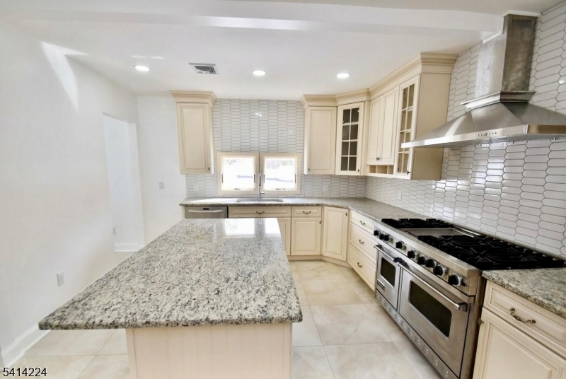 5612 Berkshire Valley Road Oak Ridge, NJ 07438 - Photo 7 of 19 a kitchen with stainless steel appliances granite countertop a sink stove and cabinets