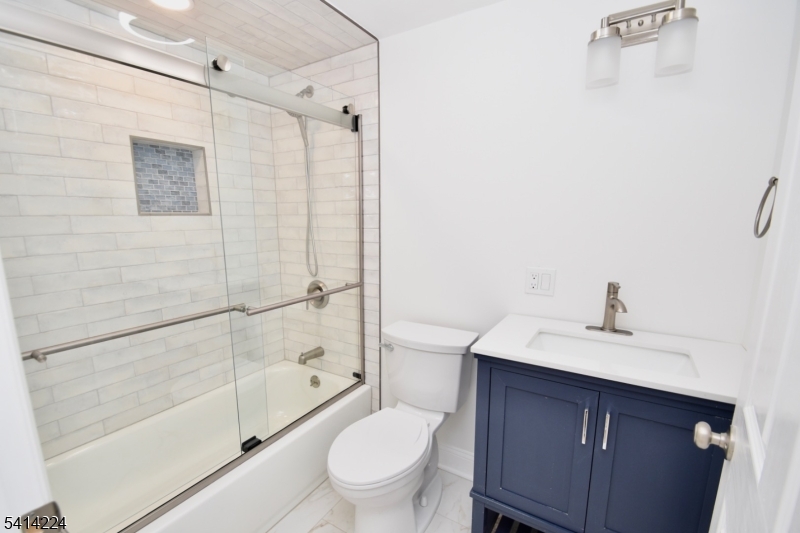 5612 Berkshire Valley Road Oak Ridge, NJ 07438 - Photo 10 of 19 a bathroom with a sink toilet and shower