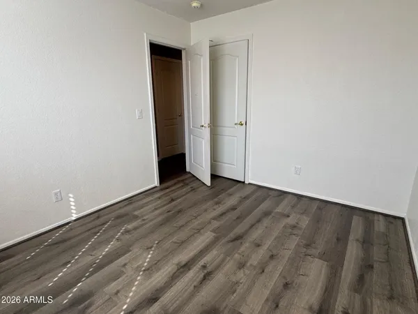 a view of a room with wooden floor and a sink