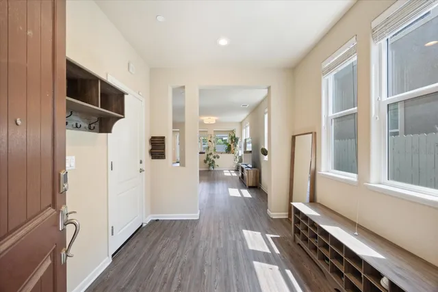 a view of a hallway view with wooden floor and staircase