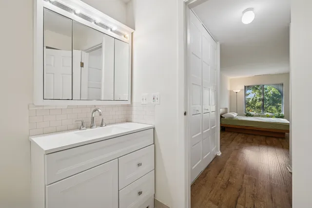 a bathroom with a sink a toilet and a mirror