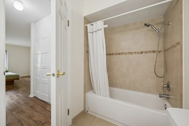 a bathroom with a bathtub and a shower