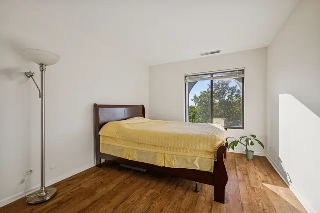 a bed sitting in a bedroom next to a window