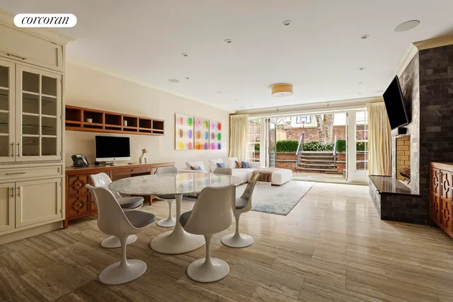 a living room with furniture a flat screen tv and wooden floor
