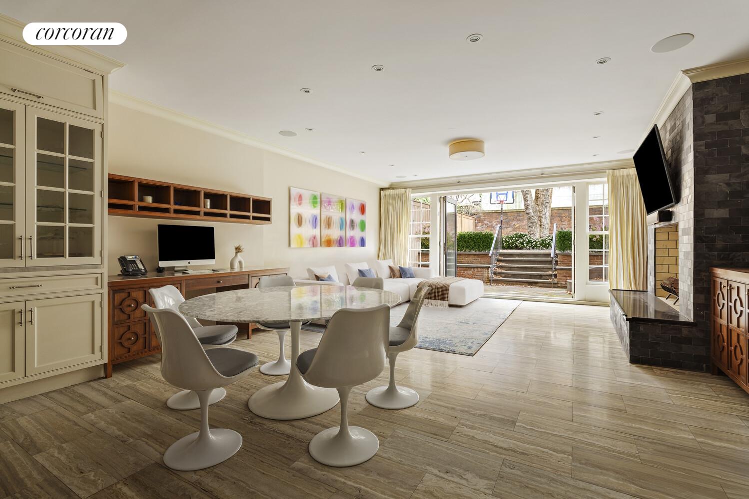 435 East 87th Street Manhattan, NY 10128 - Photo 12 of 36 a living room with furniture a flat screen tv and wooden floor