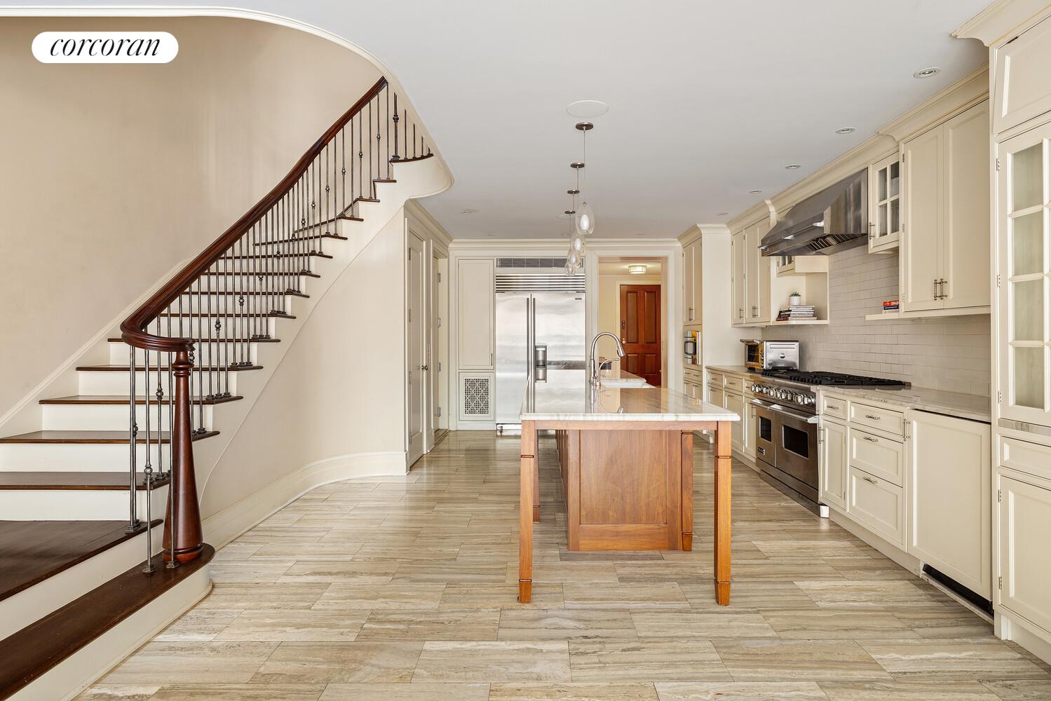 435 East 87th Street Manhattan, NY 10128 - Photo 17 of 36 a kitchen with stainless steel appliances granite countertop a stove top oven a sink dishwasher and a refrigerator with wooden floor