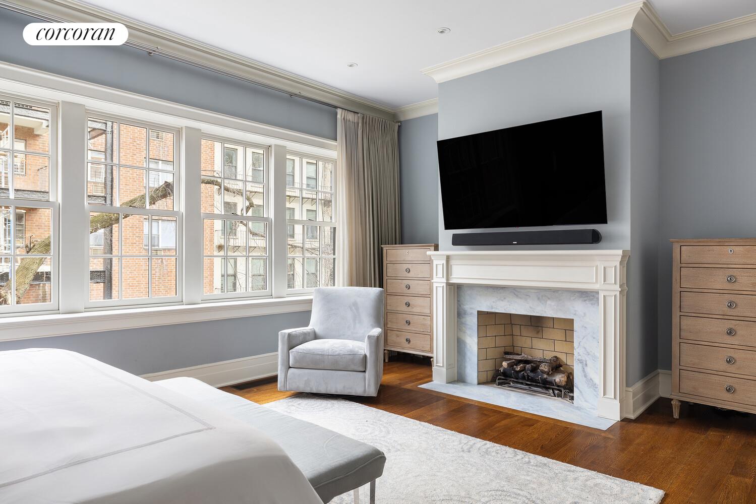 435 East 87th Street Manhattan, NY 10128 - Photo 19 of 36 a bedroom with a bed and a fireplace