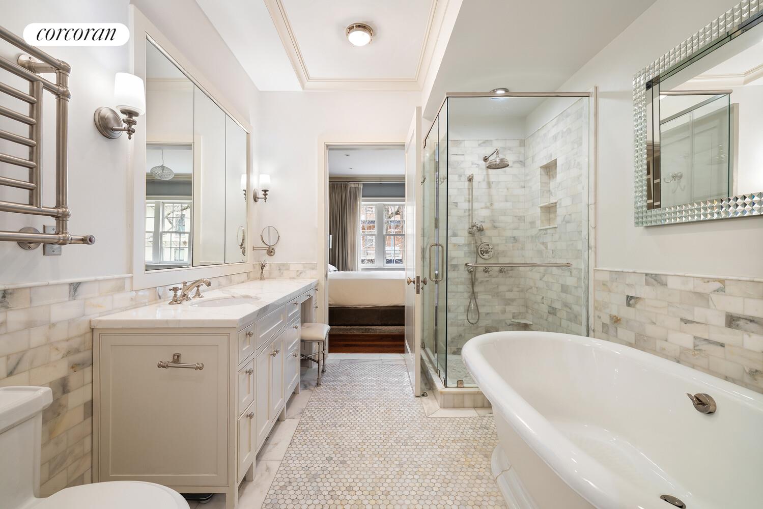 435 East 87th Street Manhattan, NY 10128 - Photo 20 of 36 a bathroom with a bathtub sink mirror and toilet