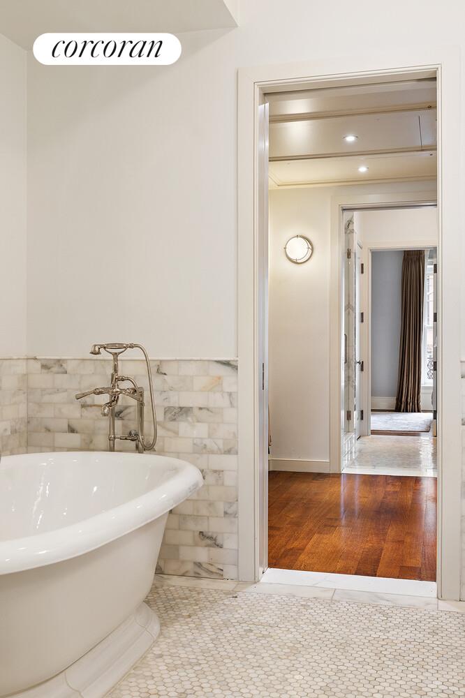 435 East 87th Street Manhattan, NY 10128 - Photo 21 of 36 a bathroom with a bathtub and a shower